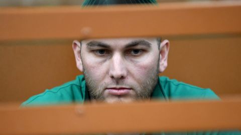 Accused Shadid Gubashev stands inside a defendants' cage at a court hearing in Moscow on Tuesday.