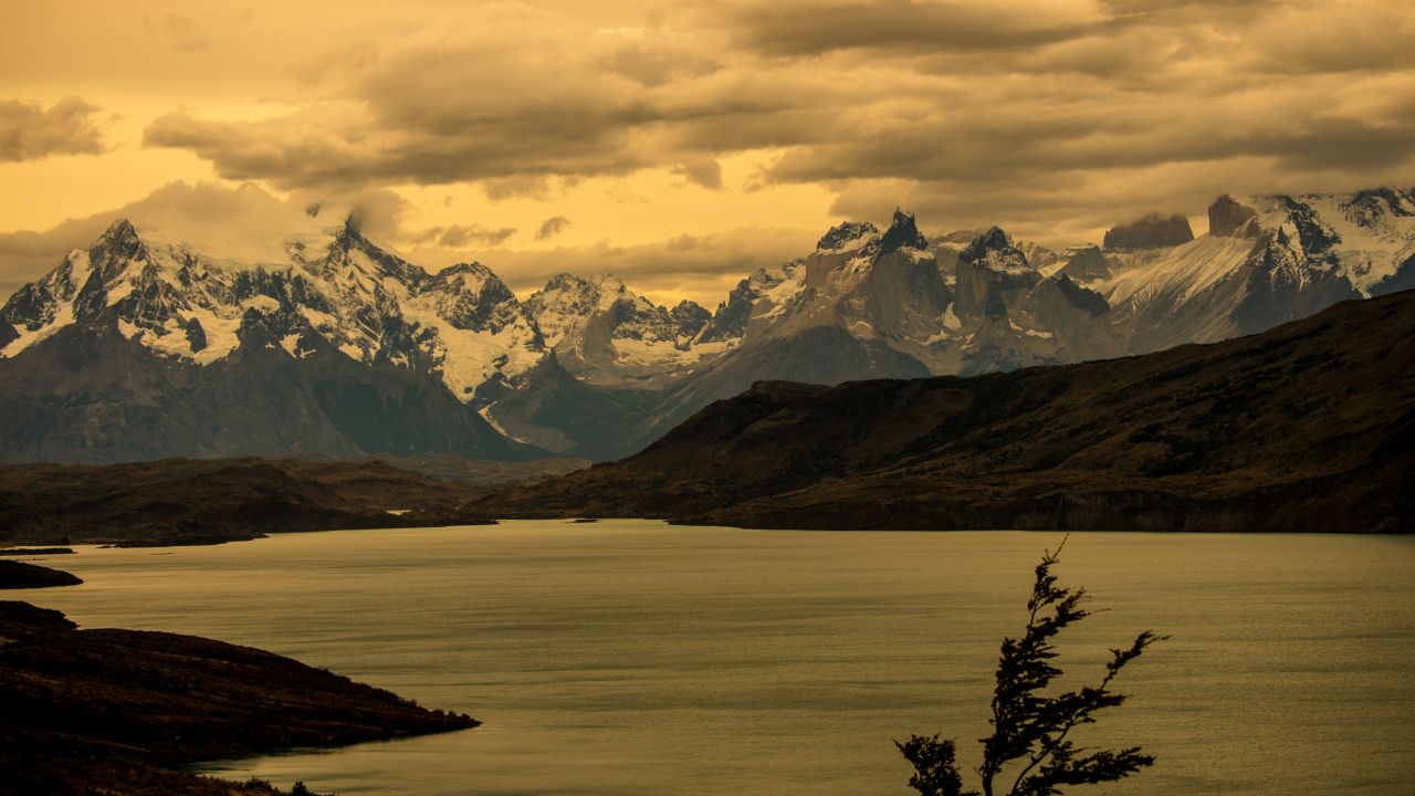 View of the Paine small mountain group located in the 230,000 hectare Torres del Paine National Park in the Chilean Patagonia, about 1,960 km south of Santiago, taken on February 26, 2016. Patagonia is a sparsely populated region located at the southern end of South America, shared by Argentina and Chile. The region comprises the southern section of the Andes mountains as well as the deserts, steppes and grasslands east of this southern portion of the Andes. Patagonia has two coasts; a western one towards the Pacific Ocean and an eastern one towards the Atlantic Ocean.  AFP PHOTO / MARTIN BERNETTI / AFP / MARTIN BERNETTI        (Photo credit should read MARTIN BERNETTI/AFP/Getty Images)