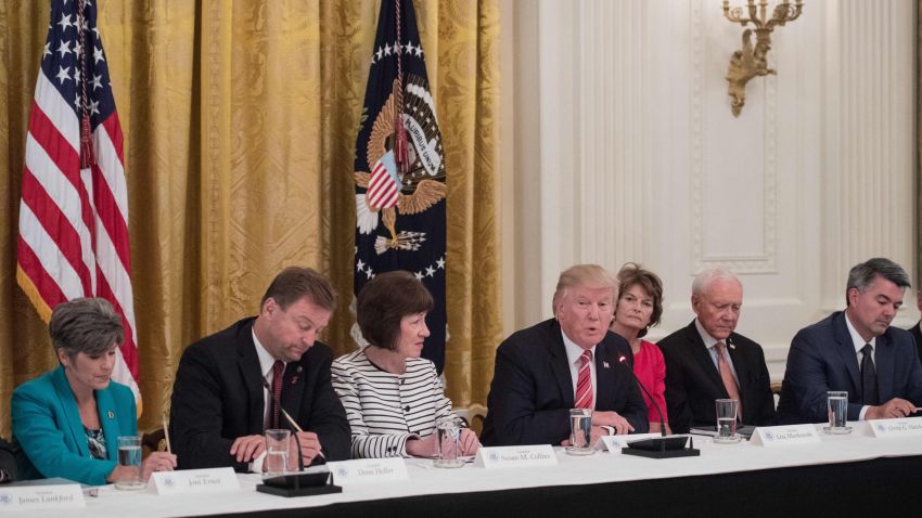 US President Donald Trump is flanked by US Senators Joni Ernst (L) of Iowa, Dean Heller (2nd L) of Nevada, Susan Collins (3rd L) of Maine, Lisa Murkowski (3rd R) of Alaska Orrin Hatch (2nd R) of Utah and Cory Gardner (R) of Colorado as Republican senators meet with Trump to discuss the healthcare bill at the White House in Washington, DC, on June 27, 2017. / AFP PHOTO / NICHOLAS KAMM        (Photo credit should read NICHOLAS KAMM/AFP/Getty Images)