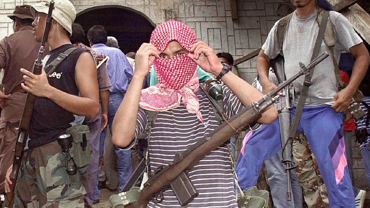 ASG rebels holding Western hostages taking position outside a mosque in their stronghold in Jolo island in the southern Philippines.