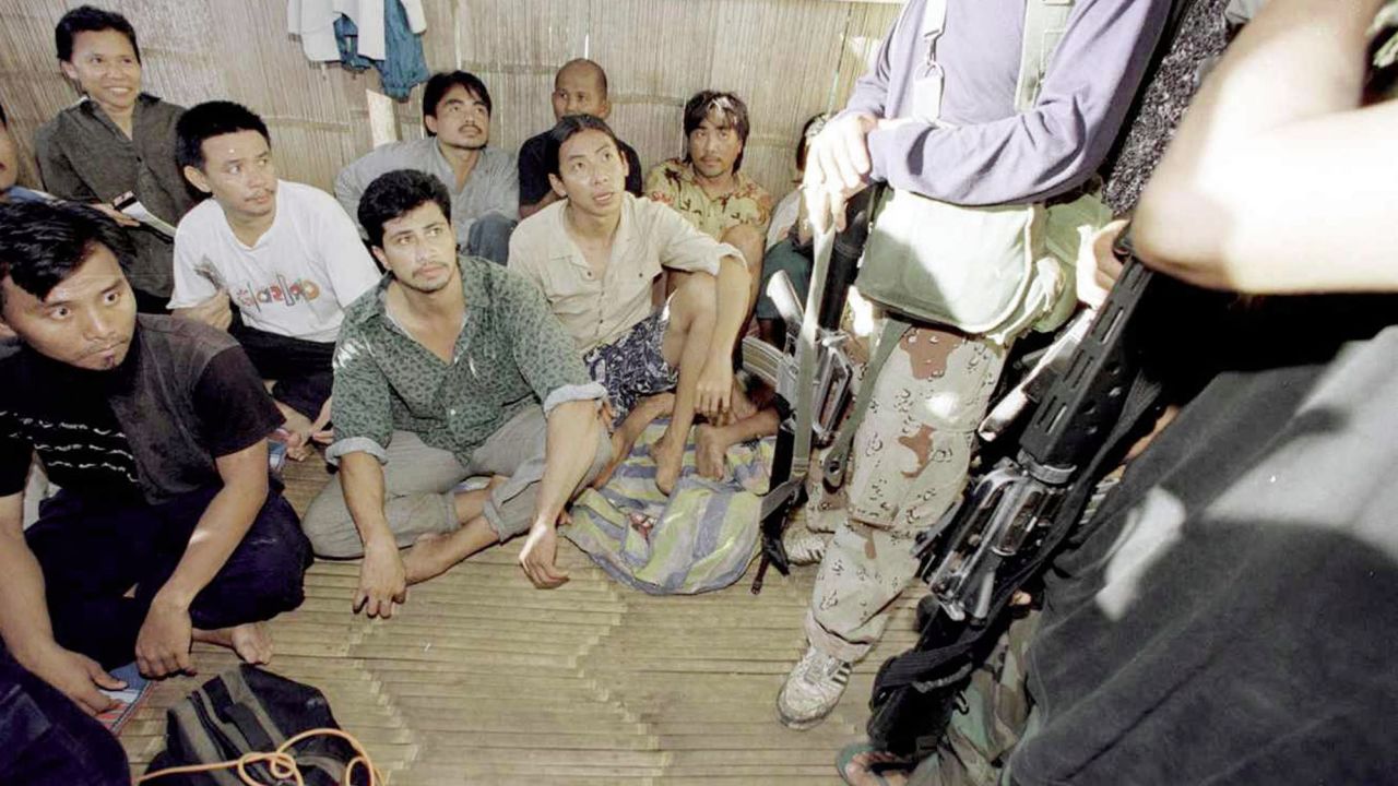 Malaysian hostages are guarded by two ASG militants in 2000.