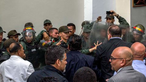 Members of the National Guard clash with deputies of the National Assembly in the courtyard of the Parliament in Caracas on Tuesday.