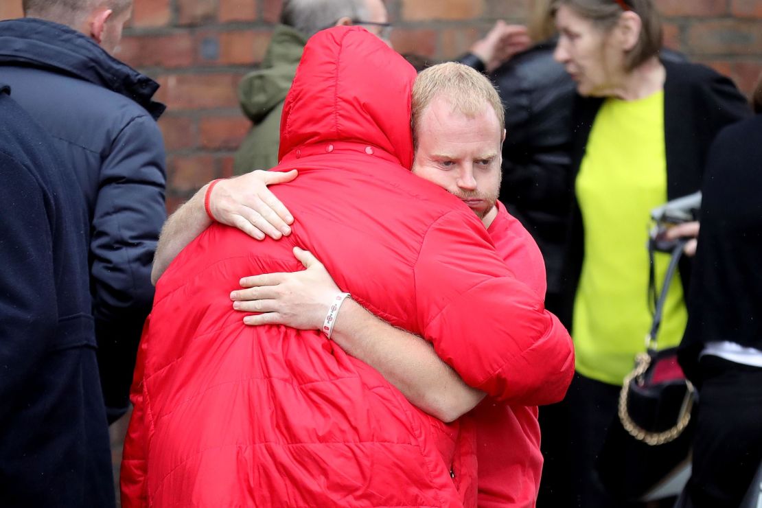 Family members react after the families of the 96 Hillsborough victims were told the decision that the Crown Prosecution Service will proceed with criminal charges.