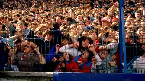 Supporters are crushed against the barrier as disaster strikes before the FA Cup semi-final match.