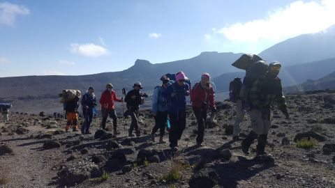 The women trek up Mount Kilimanjaro before playing their match.