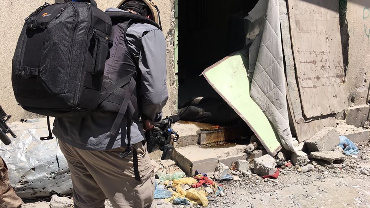 The body of an ISIS fighter lies in a doorway in the Old City.