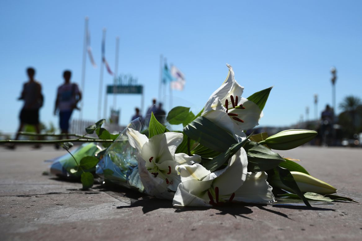 Flowers lie on the ground where a person was killed on the Promenade des Anglais.