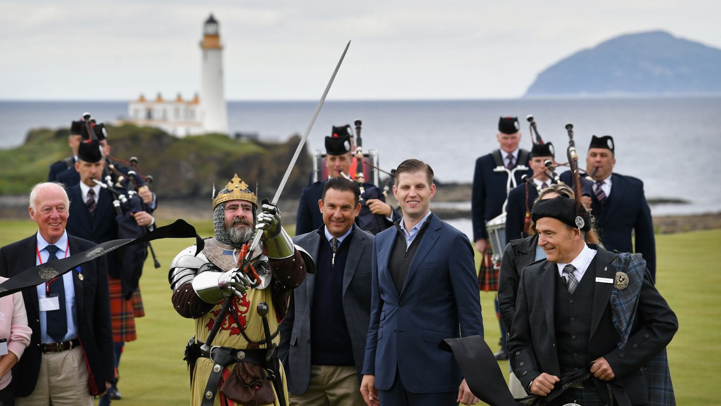 Eric Trump and his wife Lara (hidden) attend the ceremonial ribbon cutting of the "King Robert the Bruce" course at Trump Turnberry.