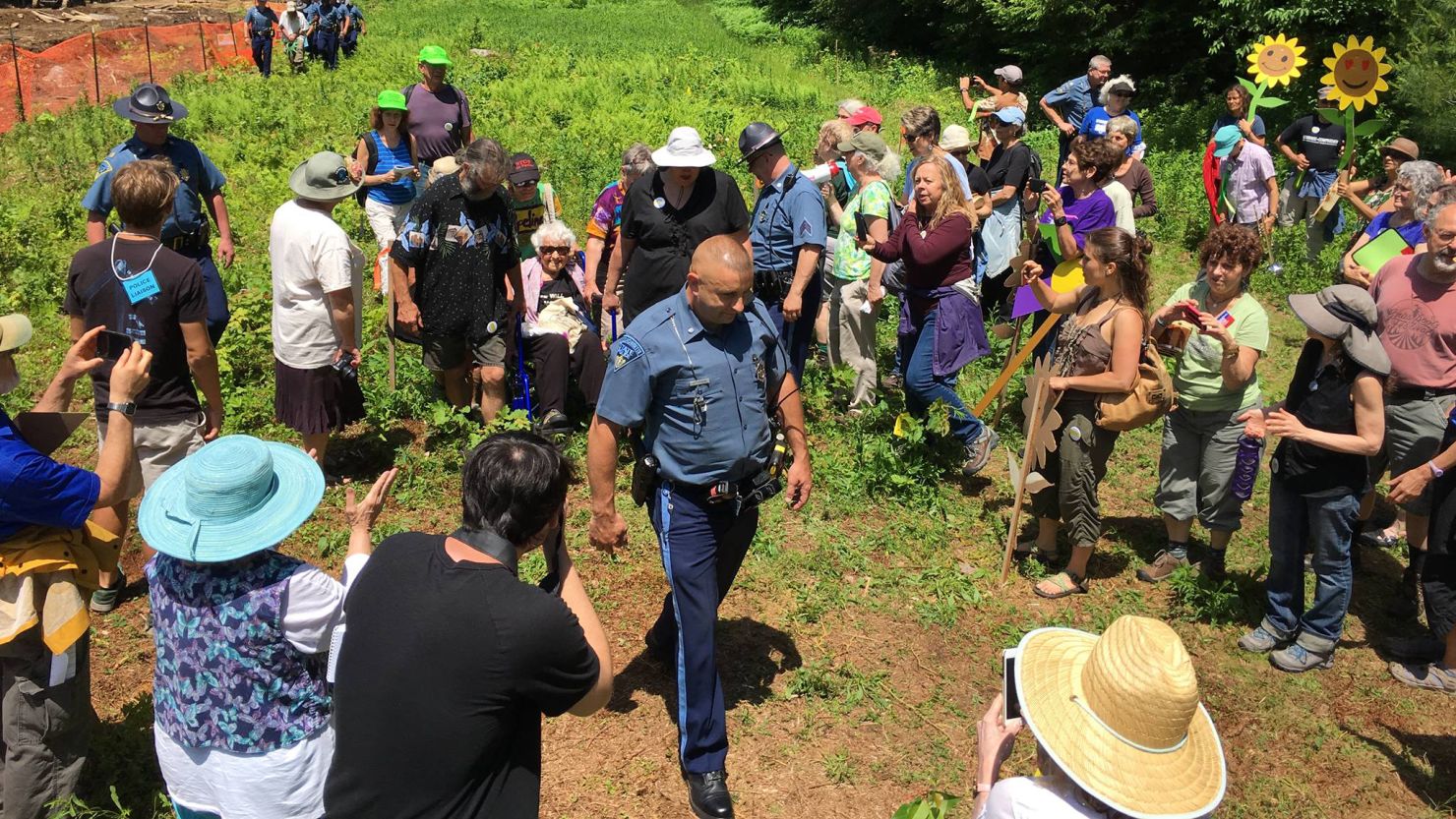 A Massachusetts State Police officer arrests longtime peace activist Frances Crowe and eight others.