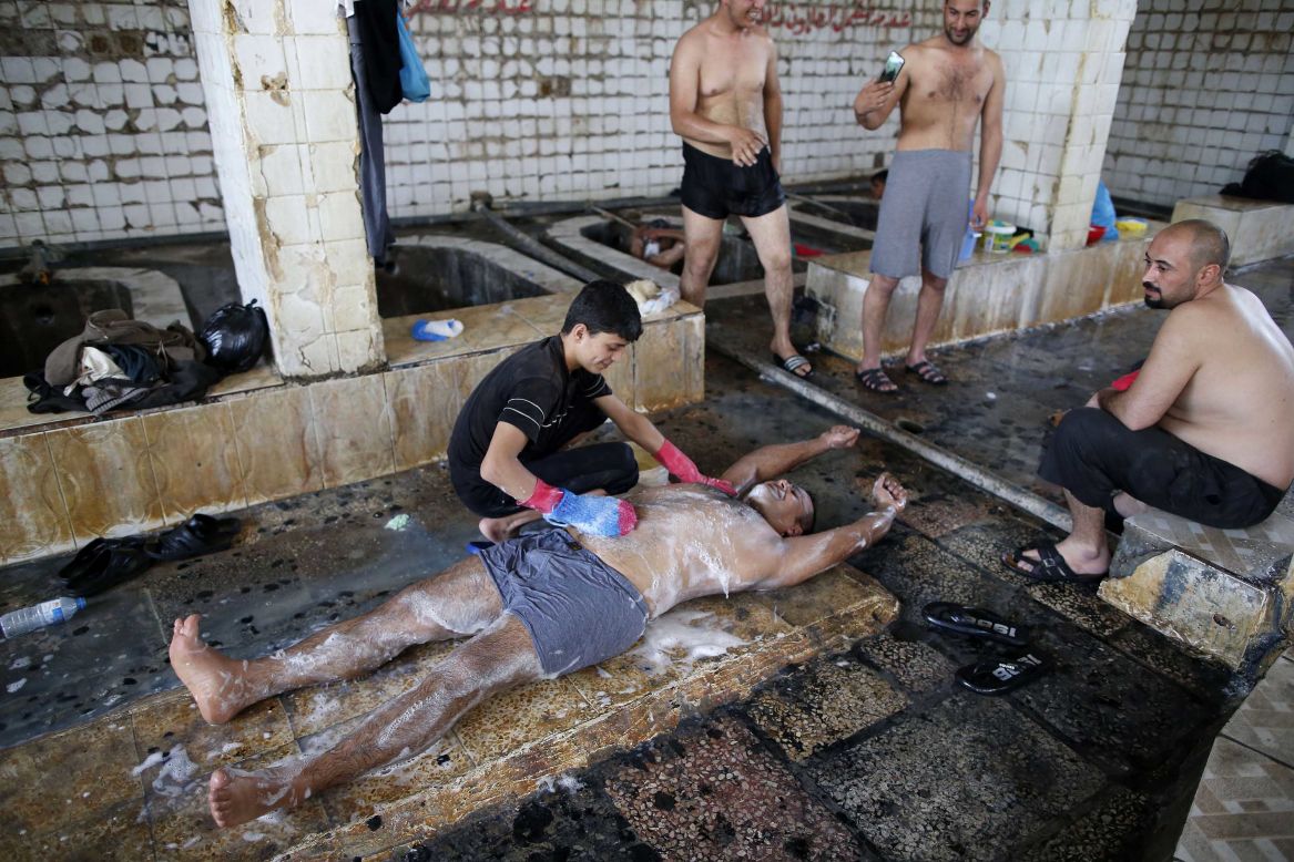 Iraqis visit a bath house on the southern outskirts of Mosul on Wednesday, April 5.