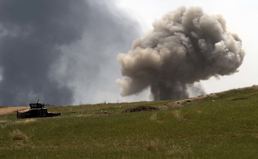 A smoke cloud rises on the front line as the Iraqi Emergency Response Division advances in west Mosul on Saturday, May 6.