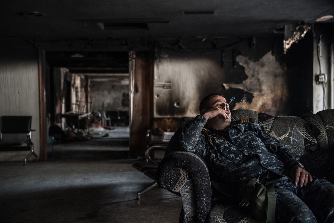 An Iraqi federal policeman smokes during a break from battle on Wednesday, April 12.