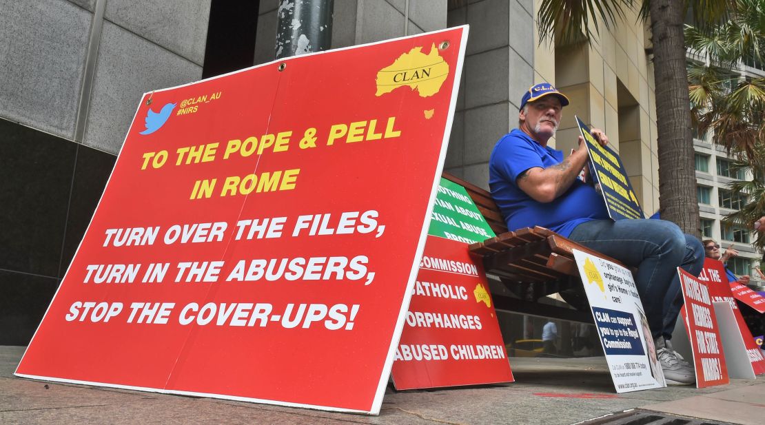 A protester holds a placard outside Australia's Royal Commission into child sex abuse in Sydney in March 2016.