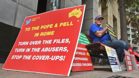 A protester holds a placard outside Australia's Royal Commission into child sex abuse in Sydney in March 2016.