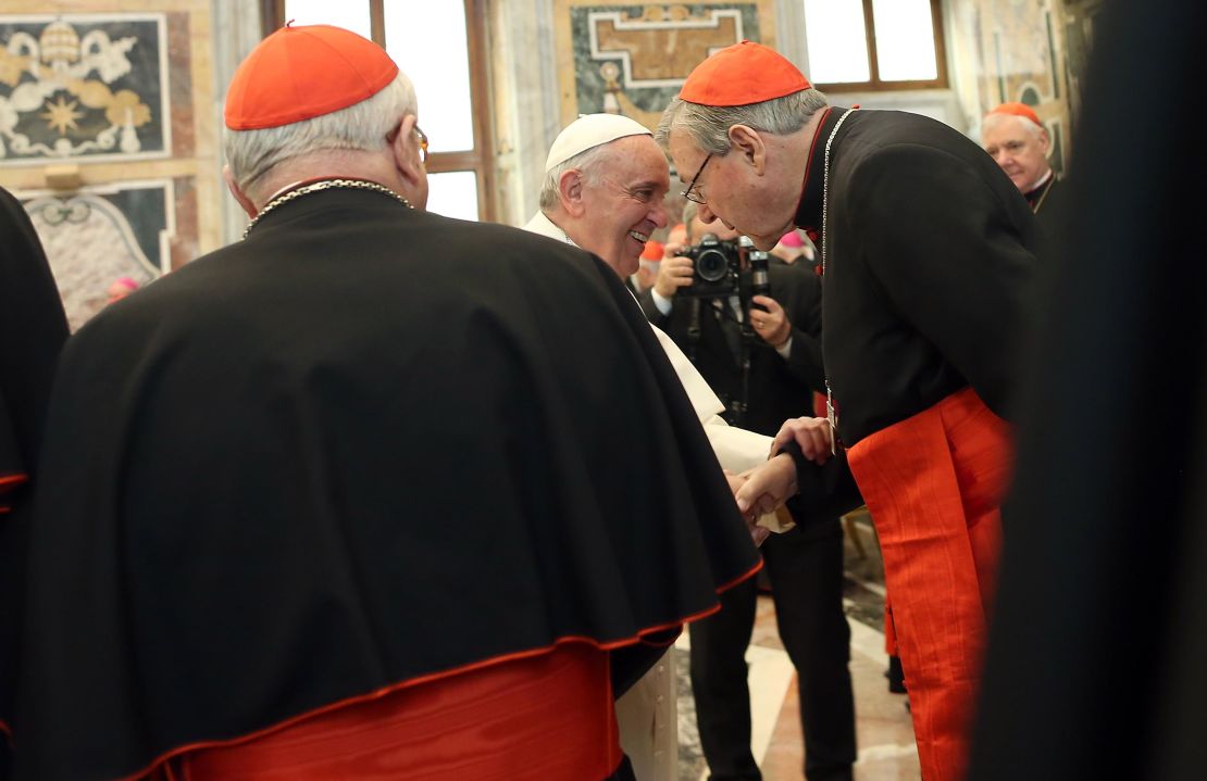 Pope Francis exchanges Christmas greetings with Cardinal George Pell (right) in 2014 in Vatican City.