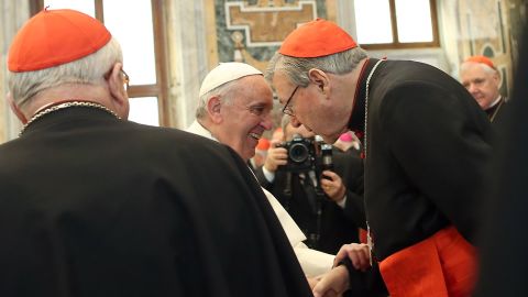 Pope Francis exchanges Christmas greetings with Cardinal George Pell (right) in 2014 in Vatican City.