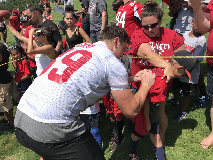 Gray was signed by the NFL's Atlanta Falcons in May 2017 having never played a game of American football. He's pictured signing a fan's shirt at a pre-season mini-camp. 