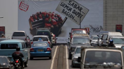 A billboard for Sampoerna cigarettes rises above traffic in downtown Jakarta, Indonesia, in 2005. 
