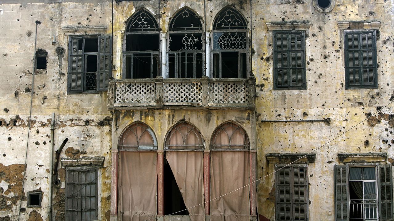 The balcony of an old house in Beirut strewn with bullet holes.