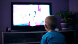 Boy watching television in dark living room; Shutterstock ID 656496229; PO: CNN Photos