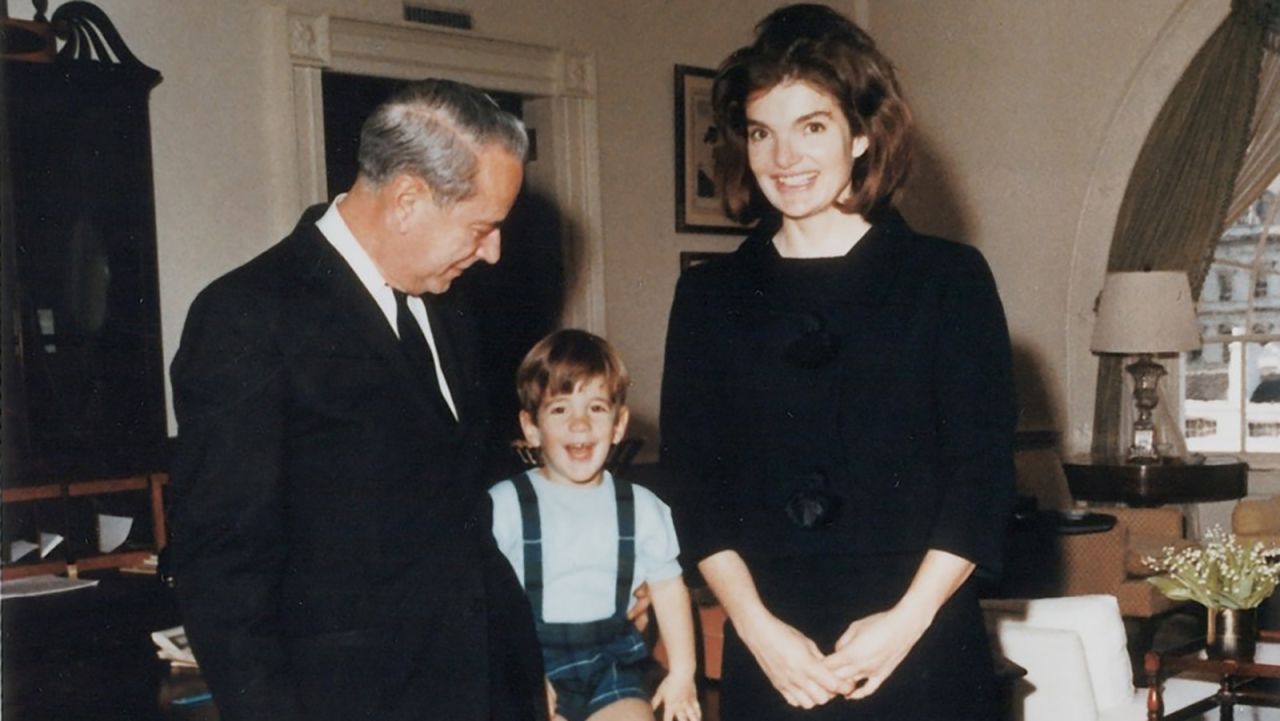 J.B. West, chief usher from 1957 to 1968, poses in the West Sitting Hall with Jacqueline Kennedy and John Kennedy Jr. prior to their departure from the White House following the assassination of President Kennedy. 