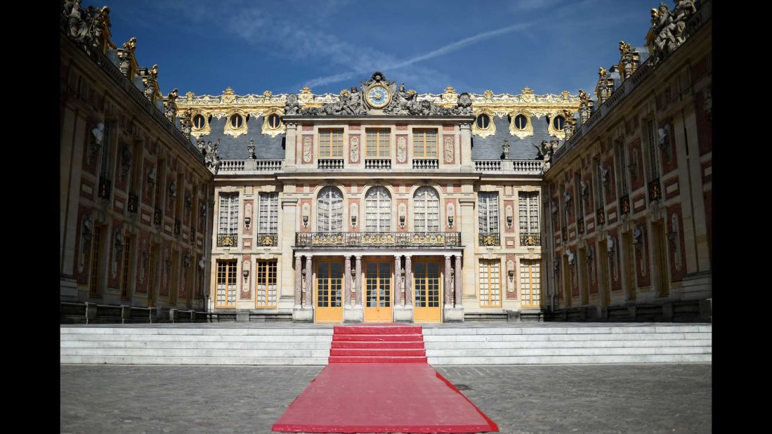 A red carpet set in the courtyard of Versailles.