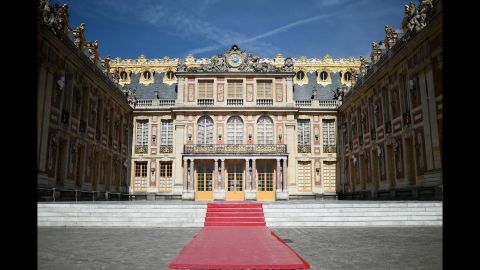 A red carpet set in the courtyard of Versailles.