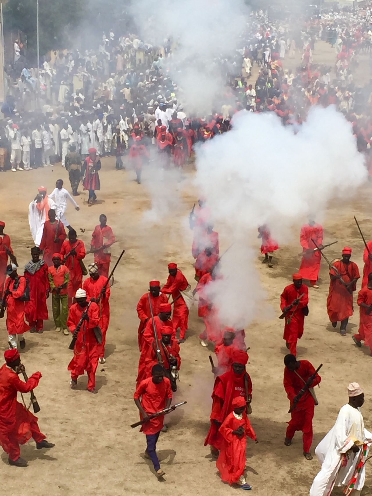 The Durbar features a parade of vibrantly clad horsemen in colorful traditional robes and turbans who process by regiments to the Emir's palace led by local leaders, local musicians and traditional performers setting off loud muskets to a delighted palace audience as they honor the Emir.