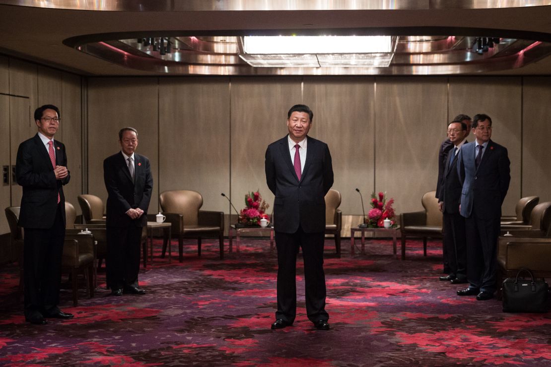 China's President Xi Jinping, center, waits to meet with Hong Kong's chief executive Leung Chun-ying at a hotel in Hong Kong on June 29.