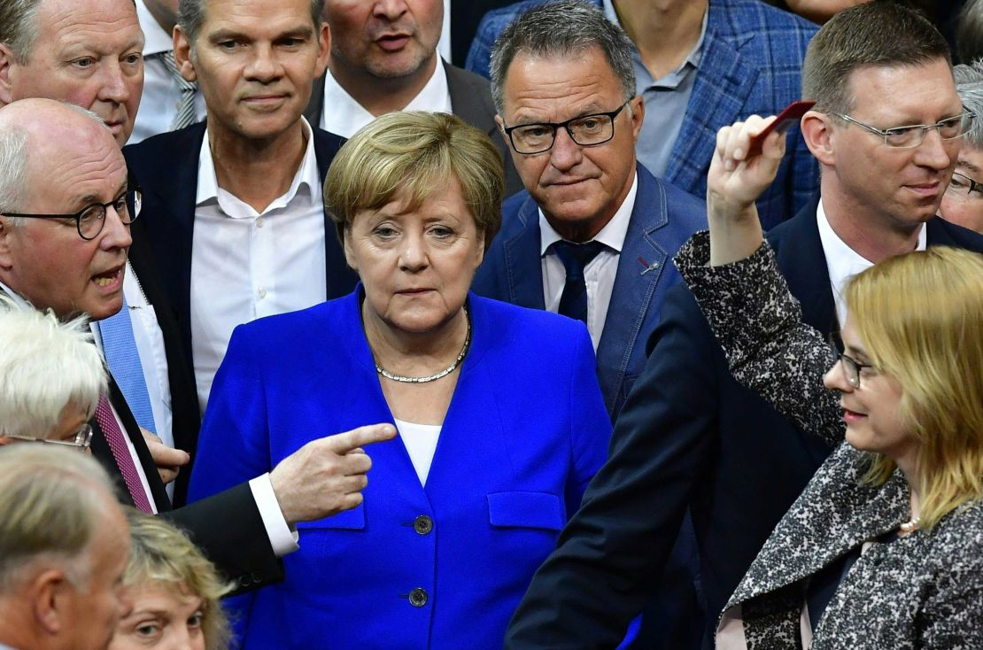 Chancellor Angela Merkel and other lawmakers line up to vote on same-sex marriage.