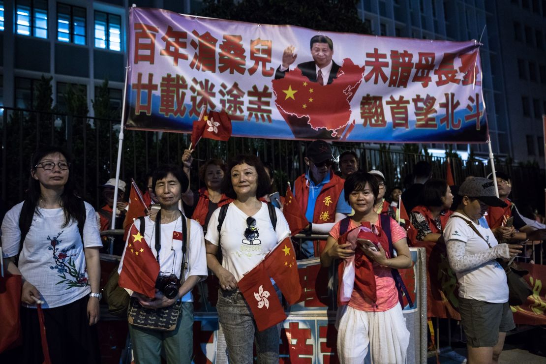 Pro-China supporters gather along a road during Xi's visit  on June 29, 2017. 
