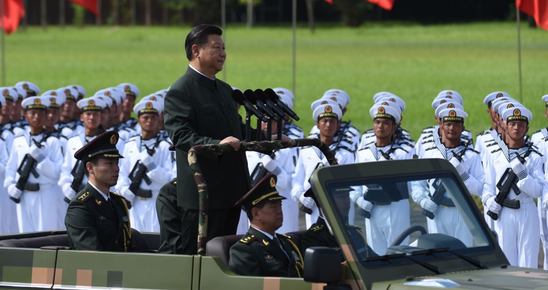 Chinese President Xi Jinping begins a review of troops from a car during a military parade in Hong Kong on June 30, 2017.
