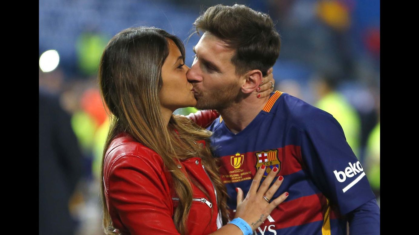 FC Barcelona's Lionel Messi kisses long-time girlfriend Antonella Roccuzzo as they celebrate Barcelona's win over Sevilla in the Copa del Rey final in Madrid in May 2016.