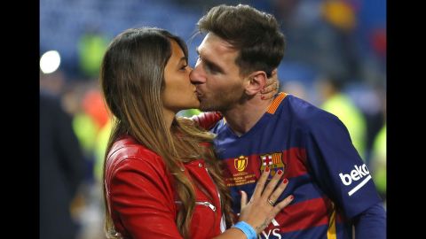 FC Barcelona's Lionel Messi kisses long-time girlfriend Antonella Roccuzzo as they celebrate Barcelona's win over Sevilla in the Copa del Rey final in Madrid in May 2016.