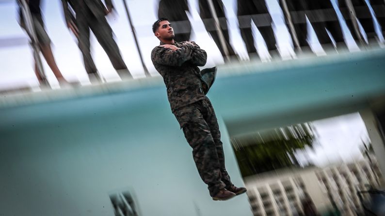 Lance Cpl. Bando Camposvilla jumps from a ten foot high tower during annual swim qualification aboard Camp Hansen, Okinawa, Japan, on June 25. The Marines complete their swim qualification to build confidence and increase survivability in the water. 