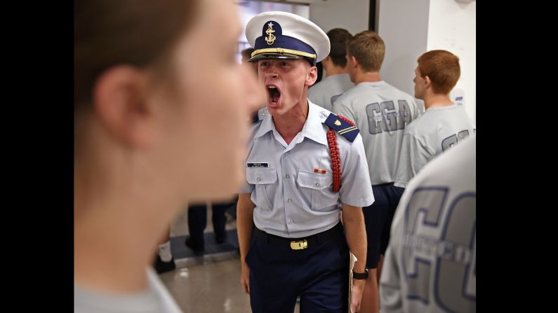U.S. Coast Guard Academy cadet Ryan Brumm shouts at members of Whiskey Two swab company as they march into the wardroom for lunch on June 26 in New London, Connecticut