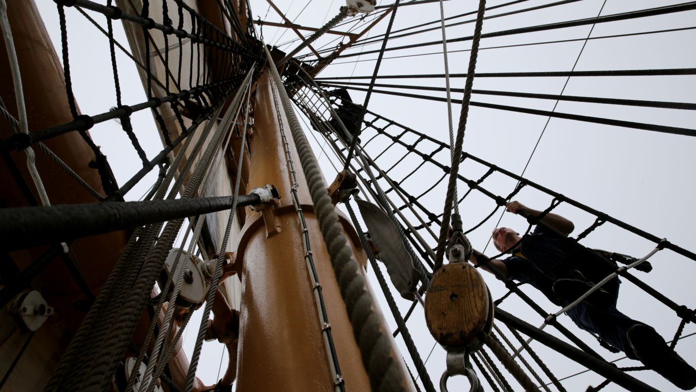 Cadets climb the rigging while preparing to set sail aboard the US Coast Guard Eagle during the Parade of Sail at Sail Boston on Saturday, June 17. The Eagle led the flotilla around the Boston Harbor. 