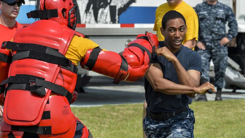 Navy Petty Officer 2nd Class Sean Morin fights off a simulated attacker after being exposed to oleoresin capsicum, or pepper spray, as part of security training in Yokosuka, Japan, on June 23.