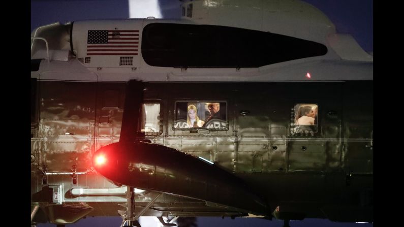 President Donald Trump, center, is seen looking out of the window of Marine One on its approach to the South Lawn of the White House in Washington, D.C. on June 13. 
