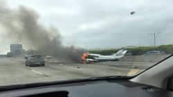 Drew Hoffman drove past a small plane that crashed on the 405 near John Wayne Airport in Santa Ana, California, on Friday.