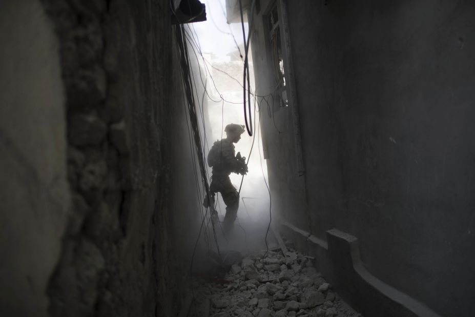 An Iraqi Special Forces soldier exchanges fire with ISIS militants in the Old City on Friday, June 30.