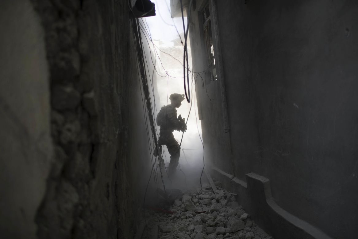 An Iraqi Special Forces soldier exchanges fire with ISIS militants in the Old City on Friday, June 30.