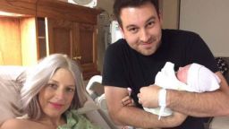 Nathan Johnson holds his new daughter, Eilee Kate, with his wife.