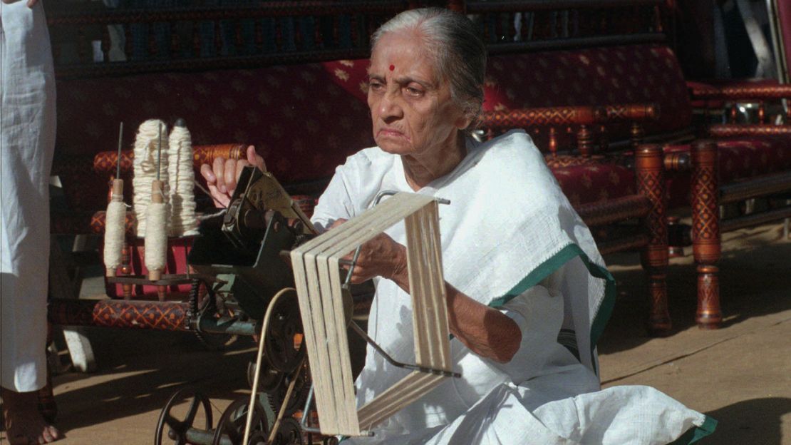 Usha Mehta spins the wheel that Gandhi used to make cotton fabrics, in Mumbai, India, on January 30, 1998.
