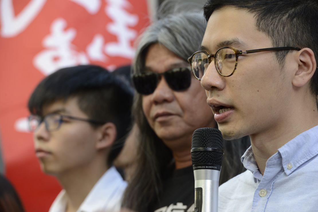 Nathan Law (right) speaks alongside fellow disqualified lawmaker "Longhair" Leung Kwok-hung and Joshua Wong.