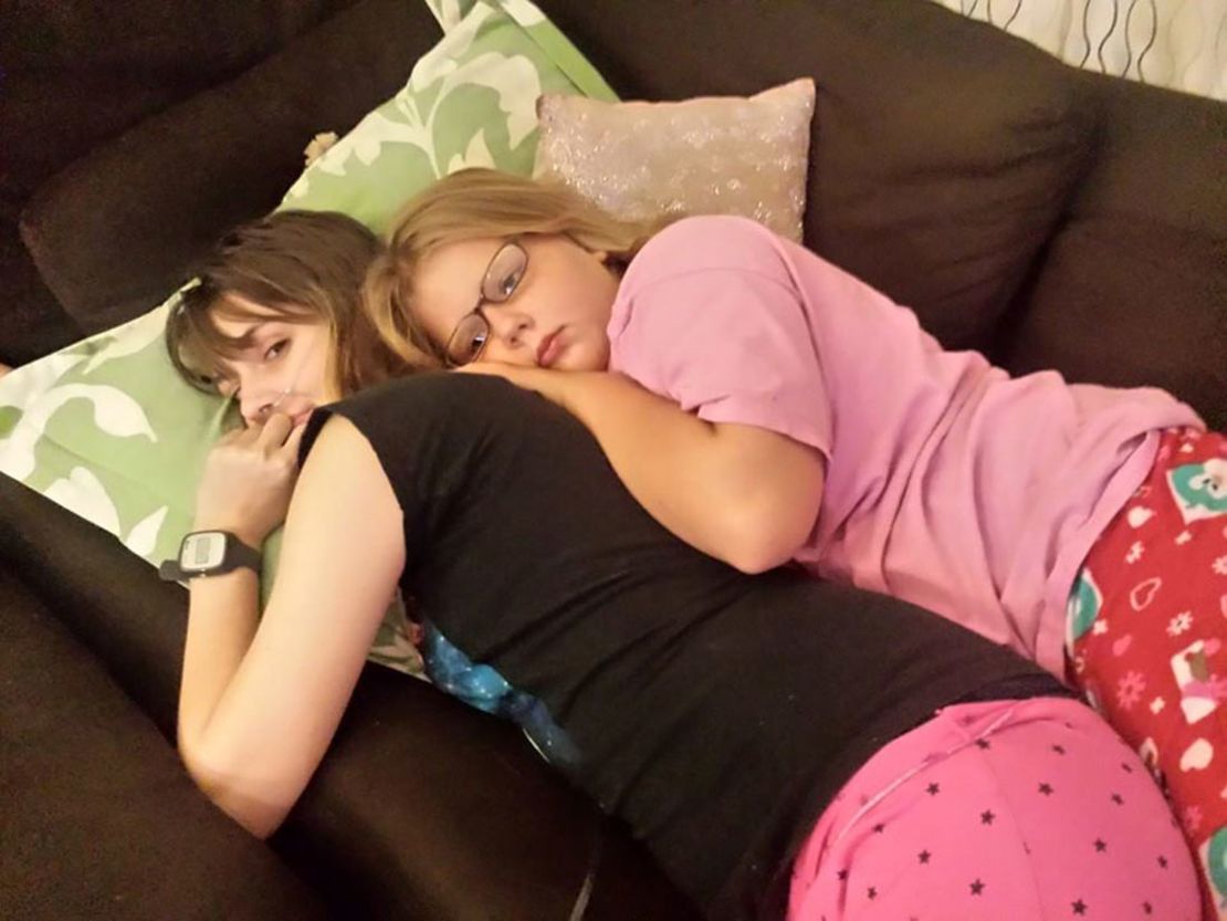 Claire and her sister, Elanore Nordquist, cuddle the night before Claire moves out of the house. One of the things Claire appreciates most about Elanore is that she's never treated Claire like a sick person.