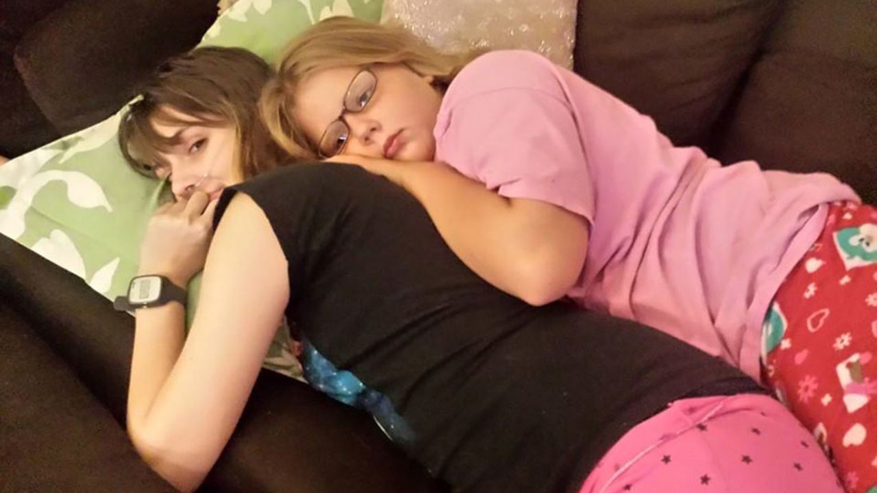 Claire and her sister, Elanore Nordquist, cuddle the night before Claire moves out of the house. One of the things Claire appreciates most about Elanore is that she's never treated Claire like a sick person.