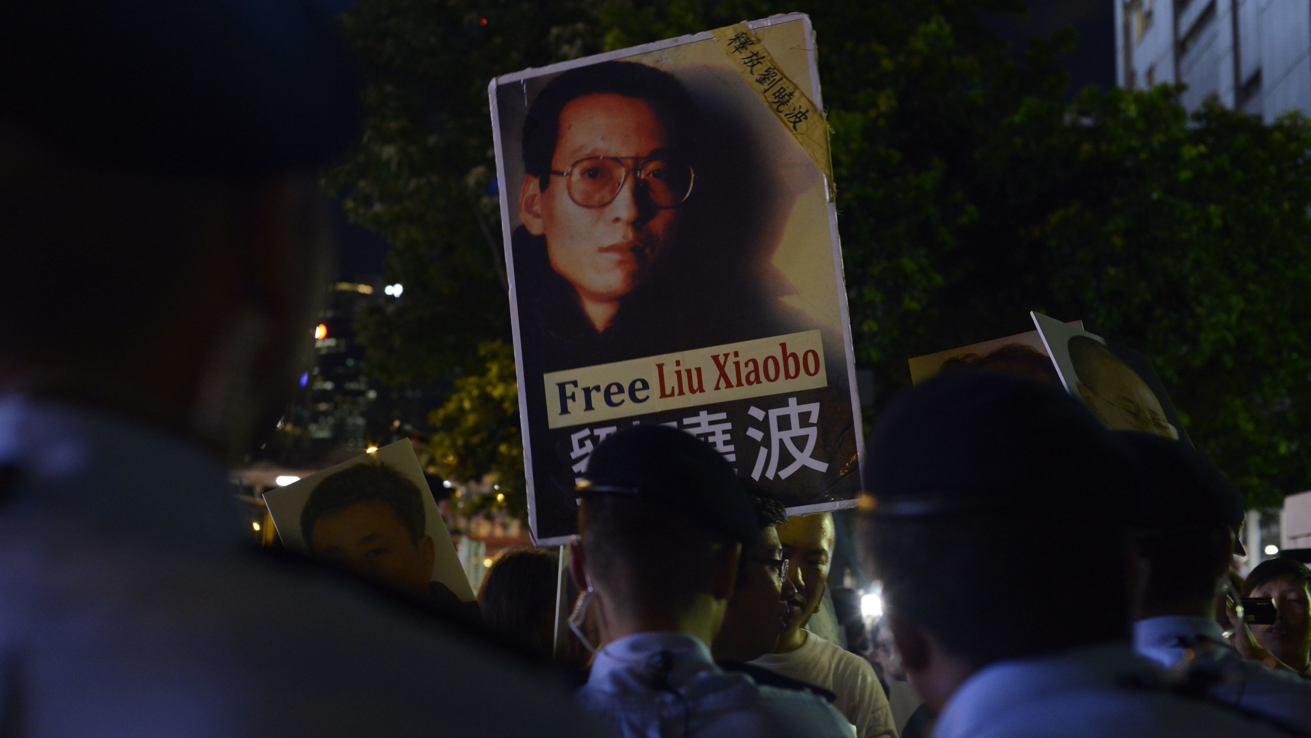 A protester holds up a picture of Chinese dissident Liu Xiaobo on June 30, 2017, in Hong Kong.