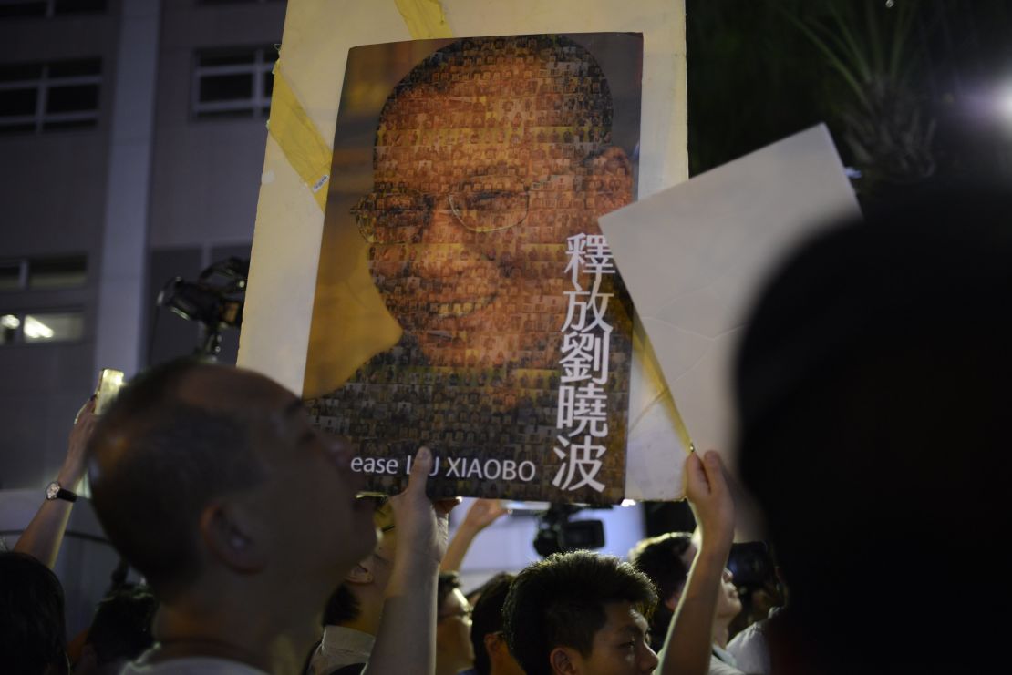 A protester holds up a picture of Chinese dissident Liu Xiaobo in Hong Kong on Friday, June 30.