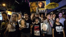 Pro-democracy supporters display posters (top) of Chinese dissident Liu Xiaobo during a protest march towards the venue where China's President Xi Jinping was attending a variety show in Hong Kong on June 30, 2017.
Tight security contained protesters in Hong Kong Friday night as China's President Xi Jinping led lavish celebrations to mark 20 years since the politically divided city was handed back to China by Britain. / AFP PHOTO / DALE DE LA REY        (Photo credit should read DALE DE LA REY/AFP/Getty Images)